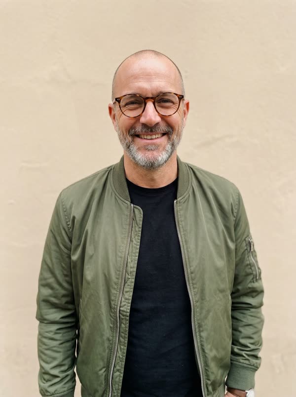 Input photo 2: fictional bald man with a grey beard and glasses wearing an olive bomber jacket